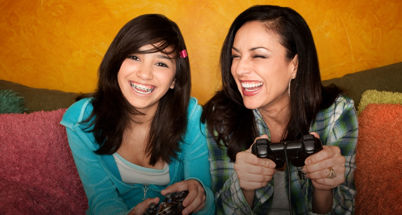 Family of four and two with braces smiling