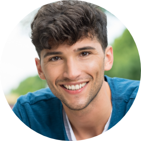 Young boy smiling by bus